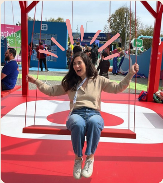 Sondra on a red swing installation